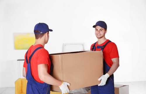 Movers preparing for a UK house move with boxes and furniture