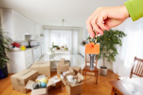 Professional movers packing fragile items for transport